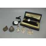 A silver and marcasite cocktail watch, silver watch and five silver fobs