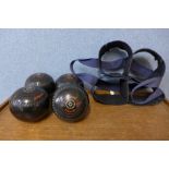 A set of four ebonised Almark lawn bowls