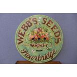 A painted wooden Webbs Seeds advertising sign