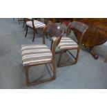 A pair of French Baumann teak sleigh chairs