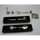 A silver pencil, a small 800 silver bell, two silver thimbles, one a/f, a medallion in a silver