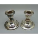 A pair of silver candlesticks, Birmingham 1909, a/f, 7cm