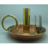 An oversized copper and brass candle holder
