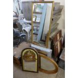 A Victorian oval gilt framed mirror and three others