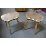 A pair of Ercol Blonde elm and beech saddle stools
