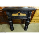 A small Baroque Revival carved and stained pine fire surround