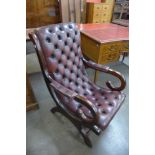 A Regency style mahogany and oxblood leather open armchair