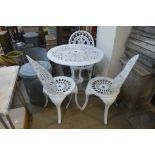 A cast aluminium garden table and three chairs