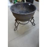 A cast metal planter on stand