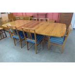 A Gordon Russell rosewood Burford extending dining table and six mahogany chairs designed by W.H.