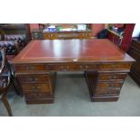 A mahogany and leather top library desk