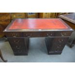 A mahogany and red leather topped pedestal desk