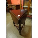 An Edward VII oak trefoil shaped drop-leaf occasional table