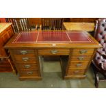 A Victorian Aesthetic Movement walnut and red leather topped desk