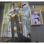 A collection of Elvis Presley memorabilia, including signed postcards, a large poster, a
