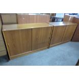 A pair of Herbert Gibbs teak sliding two door bookcases