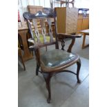 A late Victorian mahogany and green leather desk chair