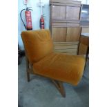 A Danish style teak and orange fabric upholstered lounge chair