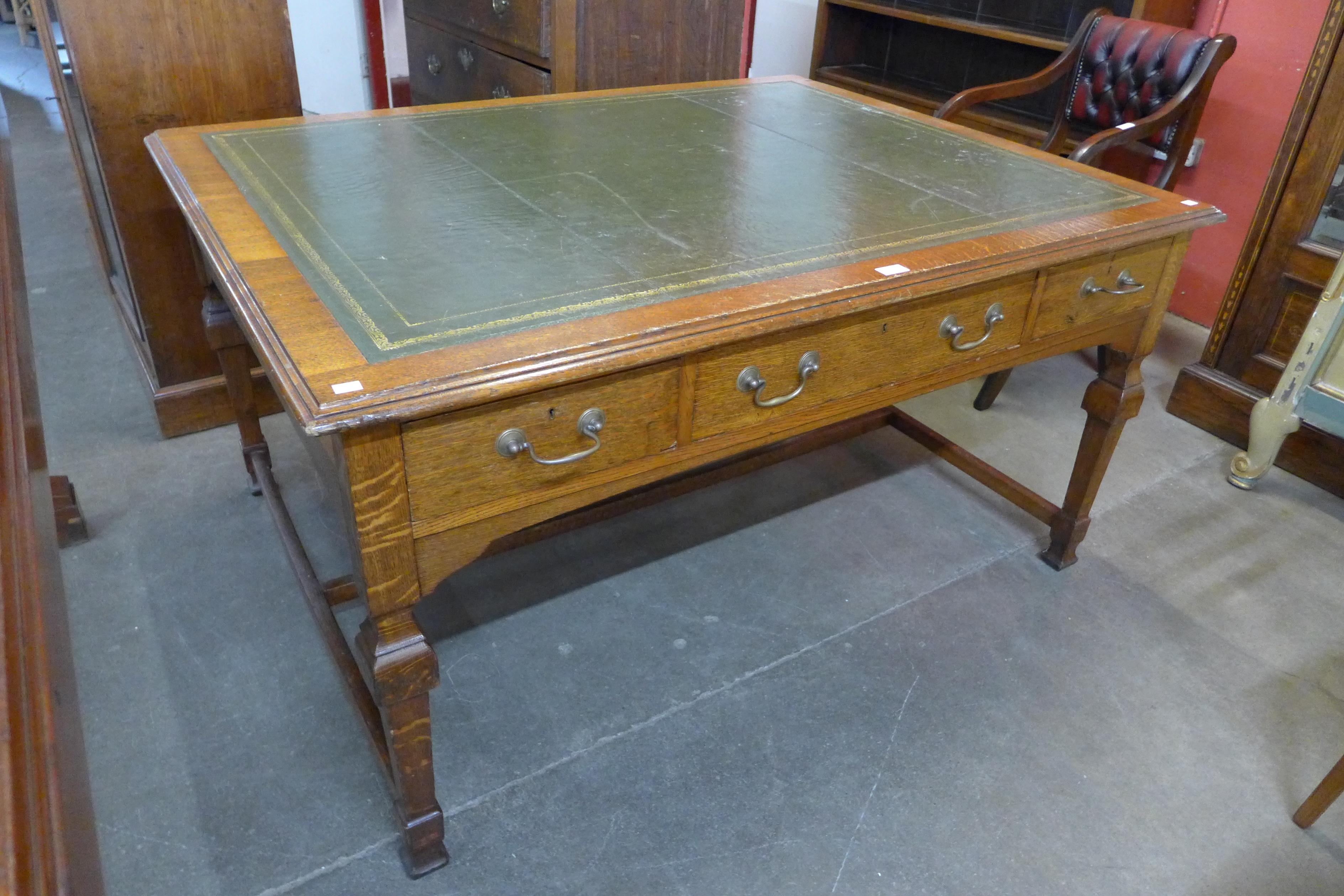 A Victorian oak and green leather topped library desk