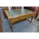 A Victorian oak and green leather topped library desk