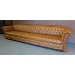 An extremely large tan leather Chesterfield settee, 72cms h, 345cms w, 90cms d