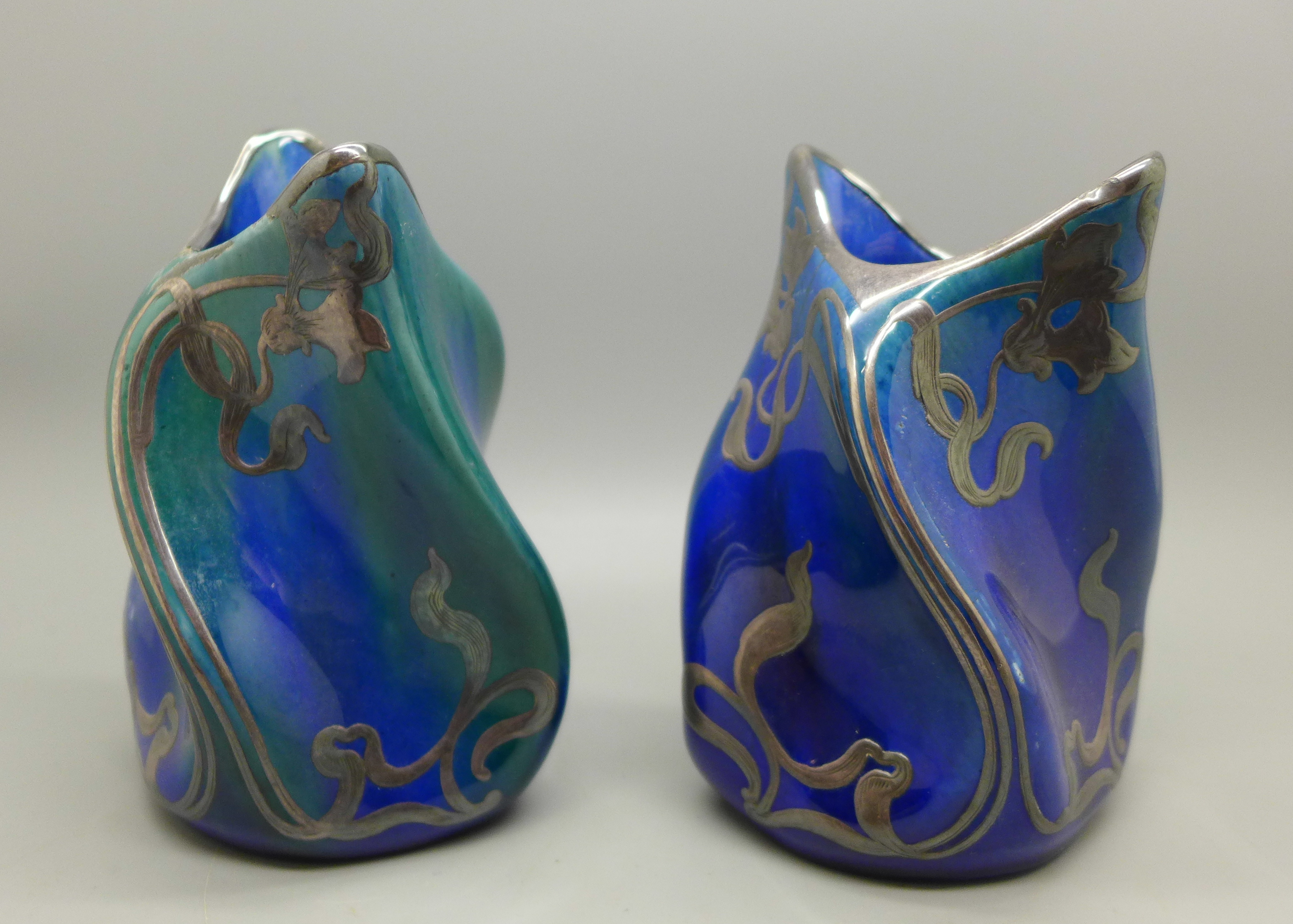 A pair of blue lustre and silver covered Art Nouveau porcelain vases, one with silver a/f, 11cm