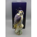 A Royal Crown Derby paperweight, Peregrine Falcon, gold stopper and red Royal Crown Derby stamp on