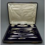 A silver mounted manicure set, boxed, replacement scissors
