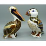 Two Royal Crown Derby paperweights, puffin with gold stopper and a brown pelican with silver stopper