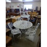 A circular cast metal garden table and four chairs, one chair a/f