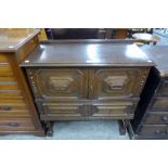 An early 20th Century oak geometric moulded cupboard