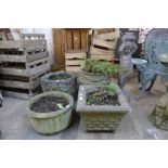 Four concrete garden planters and a concrete garden figure