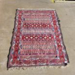 A small hand knotted red ground rug, 148cms x 100cms