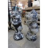 A pair of concrete lion garden ornaments