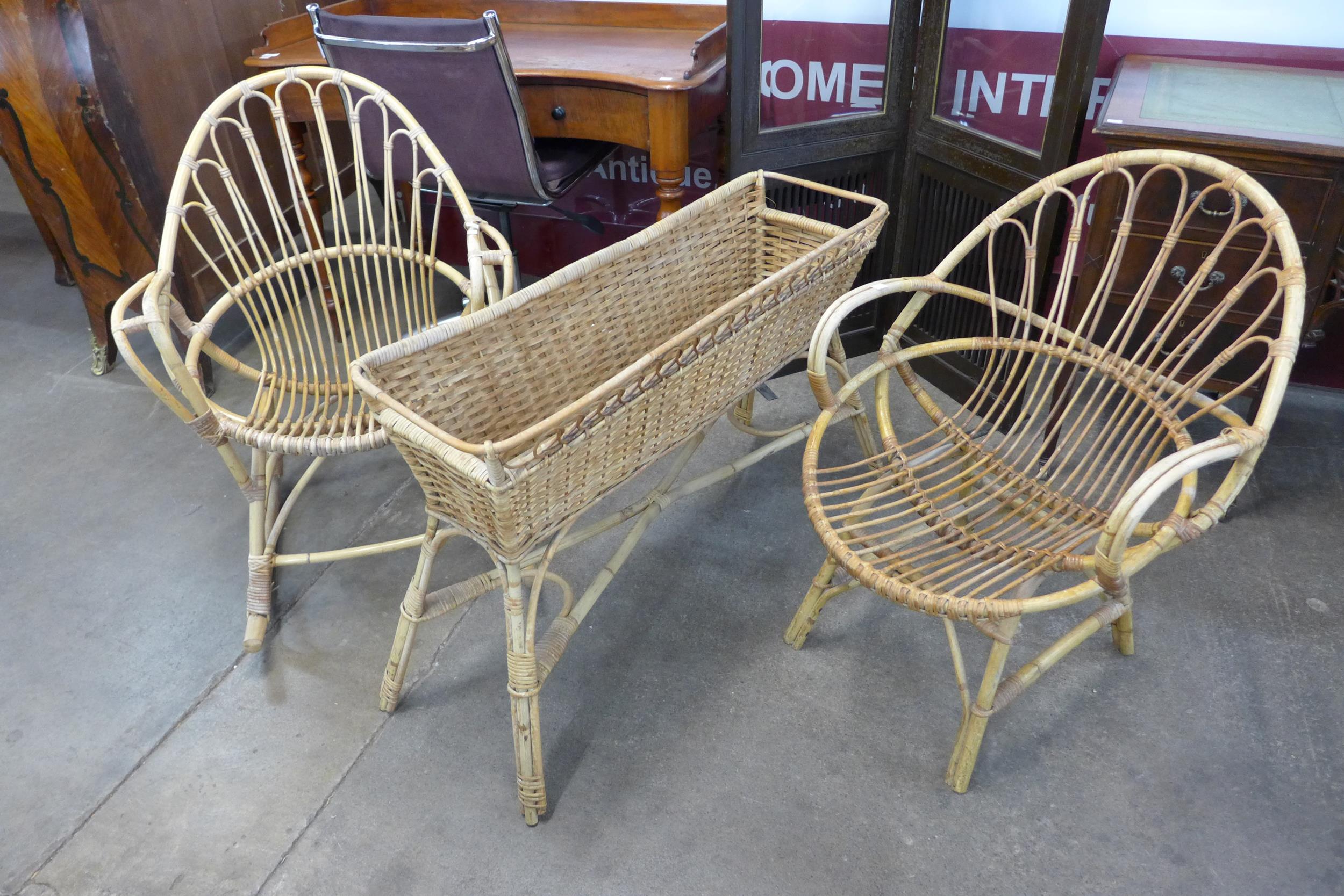 A wicker and bamboo planter, a rocking chair and another chair