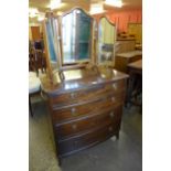 A mahogany bow front chest of drawers and a walnut dressing table mirror