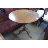 A George III oak circular tilt-top tripod tea table