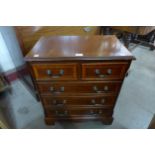 A small inlaid mahogany chest of drawers