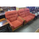 A Cintique teak and red fabric upholstered sofa and armchair