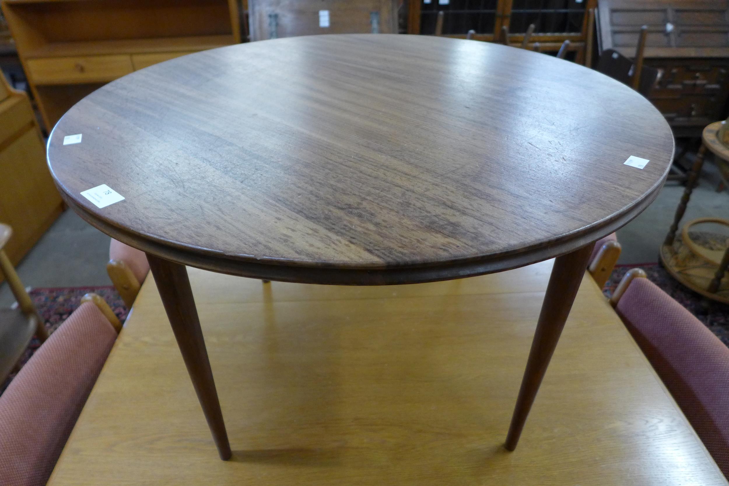 A teak circular coffee table