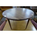A teak circular coffee table