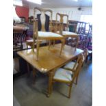 A Queen Anne style burr walnut extending dining table and six chairs