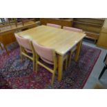 A Swedish Troeds light oak extending dining table and four chairs