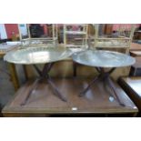 A pair of similar eastern brass topped folding occasional tables