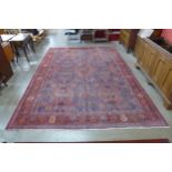 A large Persian hand knotted red ground Sanandaj rug, 394 x 275cms
