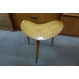 A teak boomerang shaped coffee table