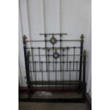 A Victorian black steel and brass double bed