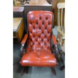 A mahogany and red leather open armchair