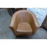 A tan leather tub chair
