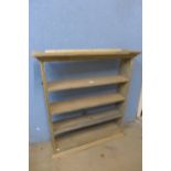 A pine open wall shelf and three chairs